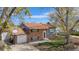 Charming brick two-story home with attached garage, well-maintained lawn, and mature trees at 11506 Fowler Dr, Northglenn, CO 80233