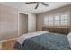 Comfortable bedroom featuring hardwood floors, closet, and shuttered windows at 11506 Fowler Dr, Northglenn, CO 80233