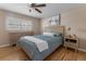 Serene bedroom with hardwood floors, ceiling fan, dresser, side tables and shuttered windows at 11506 Fowler Dr, Northglenn, CO 80233