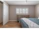 Bedroom featuring hardwood floors, closet, shuttered windows, and dresser at 11506 Fowler Dr, Northglenn, CO 80233