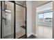 Modern bathroom featuring a tiled shower with a black frame and a built-in seat at 815 Promenade Dr, Superior, CO 80027