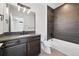 Contemporary bathroom with dark vanity, integrated sink, and combined tub and shower at 815 Promenade Dr, Superior, CO 80027