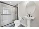 Contemporary bathroom featuring a tiled glass shower, pedestal sink, and sleek fixtures at 815 Promenade Dr, Superior, CO 80027
