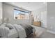 Bright bedroom with a large window, dresser, and neutral decor at 815 Promenade Dr, Superior, CO 80027