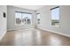 Large bedroom with light hardwood floors and windows that offer neighborhood views at 815 Promenade Dr, Superior, CO 80027