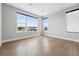 Well-lit bedroom with hardwood floors and views from large windows at 815 Promenade Dr, Superior, CO 80027