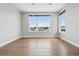 Bright, spacious bedroom with hardwood floors and large windows offering neighborhood views at 815 Promenade Dr, Superior, CO 80027