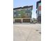 Modern townhome showcasing a tandem two-car garage and green exterior at 815 Promenade Dr, Superior, CO 80027