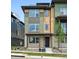 Modern townhouse with multi-tone exterior, stone accents, and manicured front yard at 815 Promenade Dr, Superior, CO 80027