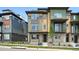 Modern townhouse with multi-tone exterior, stone accents, and landscaped front yard at 815 Promenade Dr, Superior, CO 80027