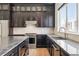 Kitchen with stainless steel appliances, modern countertops, and sleek dark cabinetry at 815 Promenade Dr, Superior, CO 80027