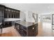 Open-concept kitchen featuring an island, stainless appliances, and dark modern cabinets at 815 Promenade Dr, Superior, CO 80027