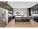 Spacious kitchen featuring an island, seating, stainless steel appliances, and dark cabinets at 815 Promenade Dr, Superior, CO 80027