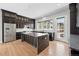Modern kitchen with an island, stainless steel appliances, and contemporary dark cabinetry at 815 Promenade Dr, Superior, CO 80027