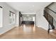 Bright, open living area flowing into kitchen, featuring hardwood floors and modern staircase at 815 Promenade Dr, Superior, CO 80027