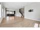 Open-concept living room with hardwood floors, recessed lighting, and staircase access at 815 Promenade Dr, Superior, CO 80027