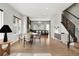 Open-concept living room with hardwood floors, modern staircase, and lots of natural light at 815 Promenade Dr, Superior, CO 80027