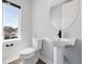 Elegant powder room with pedestal sink, modern fixtures, and natural light at 815 Promenade Dr, Superior, CO 80027