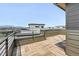 Rooftop deck with wood-look tiling, metal railing, and mountain views in the distance at 815 Promenade Dr, Superior, CO 80027