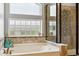 Bathroom with large tub and glass shower; a serene and modern retreat at 2307 Candleglow St, Castle Rock, CO 80109