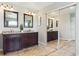 Bright bathroom featuring double vanities with granite countertops and dark wood cabinets and a large sliding door closet at 2307 Candleglow St, Castle Rock, CO 80109
