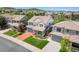 Inviting two-story home with manicured lawn and a cozy front porch, complete with a two-car garage and a red driveway at 2307 Candleglow St, Castle Rock, CO 80109