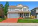 Charming two-story home with a covered porch, well-manicured lawn, and driveway at 2307 Candleglow St, Castle Rock, CO 80109