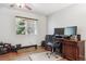 Cozy home office with a desk setup, rowing machine, and natural light from the window at 2307 Candleglow St, Castle Rock, CO 80109