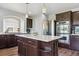 Kitchen featuring a large island, stainless appliances, wood flooring, and arched window at 2307 Candleglow St, Castle Rock, CO 80109