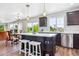 Bright, modern kitchen with a large island, stainless steel appliances, and open layout dining area at 2307 Candleglow St, Castle Rock, CO 80109