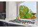 Modern kitchen featuring a gas cooktop, white countertops and a scenic window view at 2307 Candleglow St, Castle Rock, CO 80109