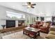 Open living area with fireplace, large window, and comfortable seating for relaxing at 2307 Candleglow St, Castle Rock, CO 80109