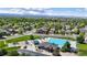 Aerial view of a community with a swimming pool, playground, green spaces, and well-maintained homes at 2990 E 135Th Dr, Thornton, CO 80241