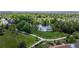 Scenic aerial view showcasing a tranquil lake surrounded by lush greenery and walking paths at 2990 E 135Th Dr, Thornton, CO 80241