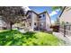 Expansive backyard showcasing a well-manicured lawn, patio area, and mature trees for privacy at 2990 E 135Th Dr, Thornton, CO 80241