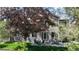 Serene backyard view featuring lush greenery, a patio seating area, and mature trees at 2990 E 135Th Dr, Thornton, CO 80241