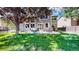 Spacious backyard with a well-maintained lawn, patio seating, and mature trees providing shade and privacy at 2990 E 135Th Dr, Thornton, CO 80241