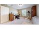 Comfortable bedroom featuring natural light, a telescope, and wood shelving perfect for a home office at 2990 E 135Th Dr, Thornton, CO 80241