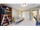 Cozy bedroom with a futon, large bookshelf, and direct access to an ensuite bathroom at 2990 E 135Th Dr, Thornton, CO 80241
