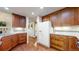 Well-lit kitchen showcasing wood cabinetry, granite countertops, and stainless steel appliances, seamlessly connecting to adjacent rooms at 2990 E 135Th Dr, Thornton, CO 80241