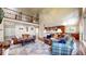 Open-concept living room with hardwood floors, a large rug, comfortable seating, and a view of the upper level at 2990 E 135Th Dr, Thornton, CO 80241