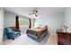 Cozy main bedroom with a ceiling fan, natural light, neutral colors, and a comfortable chair at 2990 E 135Th Dr, Thornton, CO 80241