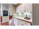 Convenient pantry space with ample storage, featuring white cabinets, a long counter, and a view into the living room at 2990 E 135Th Dr, Thornton, CO 80241