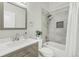 Stylish bathroom featuring a shower over tub, tiled walls, and sleek vanity with modern fixtures at 4929 W 73Rd Ave, Westminster, CO 80030