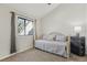Comfortable bedroom with a cozy daybed, large window, and dark storage cabinet at 4929 W 73Rd Ave, Westminster, CO 80030