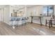 Bright dining area features a bar with seating, wood floors, and a table, perfect for modern living and entertaining at 4929 W 73Rd Ave, Westminster, CO 80030