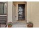 Welcoming front entrance with decorative metal door and colorful potted flowers at 4929 W 73Rd Ave, Westminster, CO 80030