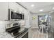 Modern kitchen featuring stainless steel appliances, granite countertops, and ample cabinet space at 4929 W 73Rd Ave, Westminster, CO 80030