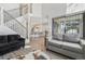 Open-concept living area with a staircase, kitchen access, and stylish decor at 4929 W 73Rd Ave, Westminster, CO 80030