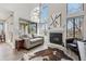 Light-filled living room featuring a fireplace, high ceilings, and contemporary furnishings at 4929 W 73Rd Ave, Westminster, CO 80030